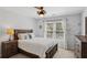 Bedroom with a plush bed, matching furniture, and natural light at 1165 Lea Dr, Roswell, GA 30076