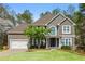 Charming two-story home with well-maintained lawn and attached two-car garage at 1165 Lea Dr, Roswell, GA 30076