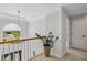Upstairs hallway with natural light and view to the entryway below at 1165 Lea Dr, Roswell, GA 30076
