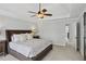 Spacious primary bedroom featuring a tray ceiling, ceiling fan, and ensuite bathroom at 1165 Lea Dr, Roswell, GA 30076