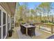 Outdoor patio deck with table and chairs overlooking a beautiful backyard and swimming pool at 1165 Lea Dr, Roswell, GA 30076