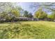 Large grassy backyard with mature trees and home in the background at 181 Bernice Dr, Lawrenceville, GA 30045