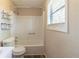 Bathroom featuring a shower-tub combo, white sink and shelves, and natural light at 181 Bernice Dr, Lawrenceville, GA 30045