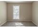 Bedroom featuring neutral carpet, white trim and a window letting in natural light at 181 Bernice Dr, Lawrenceville, GA 30045