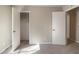 Bedroom with gray carpeting, neutral walls and closet with an open door at 181 Bernice Dr, Lawrenceville, GA 30045