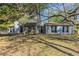 Charming single-story home with a stone facade and mature trees in a well-maintained yard at 181 Bernice Dr, Lawrenceville, GA 30045