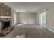 Spacious living room with a stone fireplace and sliding glass doors to the outdoor living area at 181 Bernice Dr, Lawrenceville, GA 30045