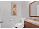 Cozy powder room featuring a wood vanity with a cream sink, framed mirror, and tile floors at 1929 Lake Heights Nw Cir # 2, Kennesaw, GA 30152
