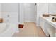 Bathroom showcasing a soaking tub, glass shower, neutral tile, and vanity area at 1929 Lake Heights Nw Cir # 2, Kennesaw, GA 30152