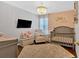 Charming Bedroom with hardwood floors, a cozy chair, and a charming crib at 1929 Lake Heights Nw Cir # 2, Kennesaw, GA 30152