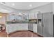 Well-lit kitchen featuring stainless steel appliances, granite countertops, and white cabinetry at 1929 Lake Heights Nw Cir # 2, Kennesaw, GA 30152
