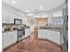 A bright kitchen with stainless steel appliances, granite countertops, white cabinetry, and open access to the dining area at 1929 Lake Heights Nw Cir # 2, Kennesaw, GA 30152