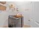 Well-organized laundry room with shelving, gray washer and dryer, and decorative laundry sign at 1929 Lake Heights Nw Cir # 2, Kennesaw, GA 30152