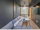Comfortable screened in porch featuring a large sofa and outdoor ceiling fan at 6626 Sterling Dr, Sandy Springs, GA 30328