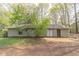 The backyard features a patio, lawn area, and privacy from mature trees at 1803 Gingham Ct, Lithonia, GA 30058
