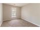 A minimalistic bedroom design with carpet flooring, a window, and neutral-colored walls at 1803 Gingham Ct, Lithonia, GA 30058