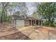 Single-story home featuring an attached garage and a concrete driveway at 1803 Gingham Ct, Lithonia, GA 30058