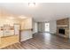 Open concept living area featuring a stone fireplace, and a view to the kitchen at 1803 Gingham Ct, Lithonia, GA 30058