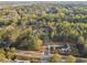 An aerial view of a residential neighborhood featuring lush green trees and well-maintained streets at 225 Maison Court, Roswell, GA 30076