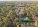 Aerial view of new construction home surrounded by lush greenery and mature trees in a desirable location at 225 Maison Court, Roswell, GA 30076