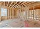 Bedroom features exposed beams, natural light, and wood studs at 225 Maison Court, Roswell, GA 30076