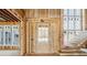 New home under construction displaying a door entryway, grand staircase, and large window placements at 225 Maison Court, Roswell, GA 30076