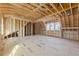 Second story during framing with a bright window, providing a glimpse into the room layout and construction progress at 225 Maison Court, Roswell, GA 30076