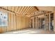 Spacious room framing, showcasing the layout of the new construction with sunlight shining through the window at 225 Maison Court, Roswell, GA 30076