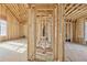 Hallway featuring exposed beams, natural light, and wood studs at 225 Maison Court, Roswell, GA 30076