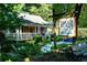 Charming Table & Main Southern Tavern, featuring a welcoming porch and lush landscaping at 225 Maison Court, Roswell, GA 30076