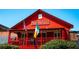 Mac McGee's Irish pub with red exterior, flags, and a cozy porch, capturing an inviting neighborhood pub at 225 Maison Court, Roswell, GA 30076