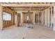 Exposed framing shows living space with planned window placements ready for customization during construction at 225 Maison Court, Roswell, GA 30076