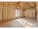 Spacious unfinished room featuring exposed wood framing, large windows, and ample natural light at 225 Maison Court, Roswell, GA 30076