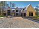 Two-story home boasts large windows, an unfinished driveway, and partial siding; the residence is currently under construction at 225 Maison Court, Roswell, GA 30076