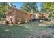 View of the home's backyard featuring a deck and mature trees at 4535 Forest Green Dr, Sugar Hill, GA 30518