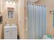 Simple bathroom features a sink, toilet and shower with a light peach paint at 4535 Forest Green Dr, Sugar Hill, GA 30518