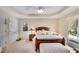 Charming bedroom featuring a wooden bed frame, ceiling fan and access to an exterior door at 4535 Forest Green Dr, Sugar Hill, GA 30518