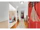 Inviting entryway with hardwood floors, a red front door, and views into the living spaces at 4535 Forest Green Dr, Sugar Hill, GA 30518