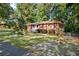 Quaint brick home featuring a well-maintained lawn and landscaping, offering inviting curb appeal at 4535 Forest Green Dr, Sugar Hill, GA 30518