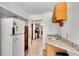 Long galley kitchen with white appliances, views into kitchen, and granite countertops at 4535 Forest Green Dr, Sugar Hill, GA 30518