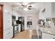 Galley kitchen with white cabinets, stainless appliances, granite countertops, and view into the dining room at 4535 Forest Green Dr, Sugar Hill, GA 30518
