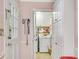 Laundry room with a white washer and dryer, white cabinets and light pink walls with a view to the backyard at 4535 Forest Green Dr, Sugar Hill, GA 30518