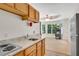 Eat in kitchen with granite countertops, wood cabinets and view into an open living space at 4535 Forest Green Dr, Sugar Hill, GA 30518
