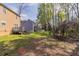 Spacious backyard with a deck, a neighboring house, and lush trees in a tranquil setting at 2030 Hilda Burns Pl, Lithonia, GA 30058