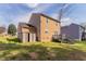 View of the backyard featuring a two-story home with siding, a small deck, and a storage shed at 2030 Hilda Burns Pl, Lithonia, GA 30058