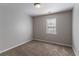 This cozy bedroom offers soft carpet, neutral walls, and a window for natural light at 2030 Hilda Burns Pl, Lithonia, GA 30058