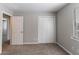 This bright bedroom features a double door closet, neutral walls, and soft carpet at 2030 Hilda Burns Pl, Lithonia, GA 30058