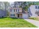 Charming two-story home with a one-car garage and a well-maintained front yard at 2030 Hilda Burns Pl, Lithonia, GA 30058