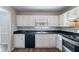 Bright kitchen featuring stainless appliances, white cabinets, and dark countertops at 2030 Hilda Burns Pl, Lithonia, GA 30058