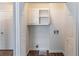 A utility closet area with a vent, a shelf, and white walls and trim at 2030 Hilda Burns Pl, Lithonia, GA 30058